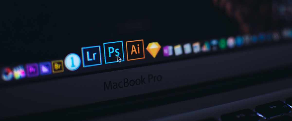 Adobe Lightroom, Photoshop and Illustrator on a MacBook Pro app dock.